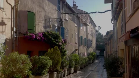 Idyllic authentic street in Saint Tropez, French Riviera, resort town in the Stock Footage 299048196