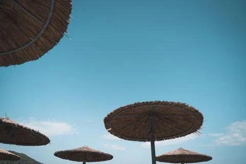 Idyllic beach scene featuring an array of beach umbrellas against a bright blue Fotos de archivo