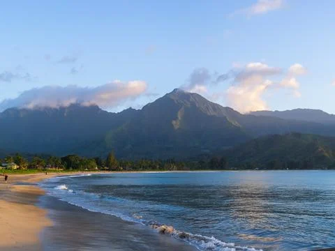 Idyllic Beach Scene with Mountain Backdrop on Kauai Stock Photos