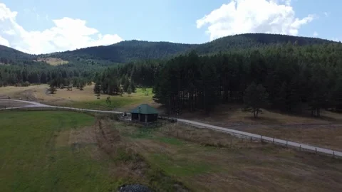 Idyllic Countryside Cabin in a Mountain Forest Landscape Stock Footage 289222575