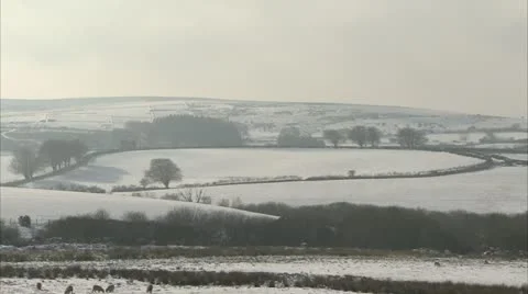 Idyllic English patchwork fields covered in a blanket of snow. Video stock 20631436