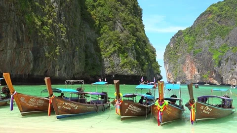 Idyllic landscape of Maya Bay with longtail boats docked near the beach Stock Footage 290456880