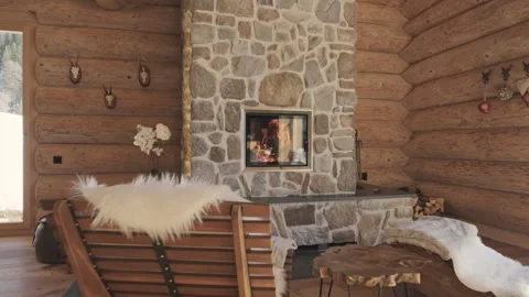 Idyllic mountain chalet interior with a warm stone fireplace and rustic wooden Stock-Footage 335199087