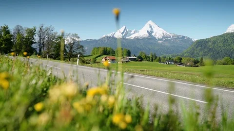 Idyllic mountain scenery in the Alps with empty country road in springtime Stock Footage 108619154