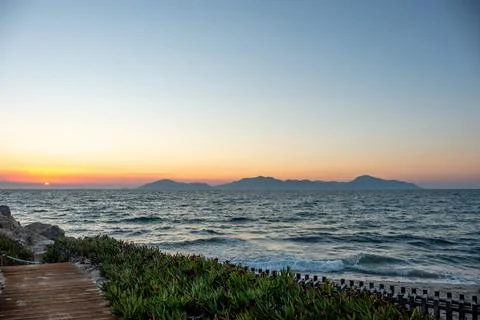 Idyllic path along the coast of Kos at sunset Stock Photos