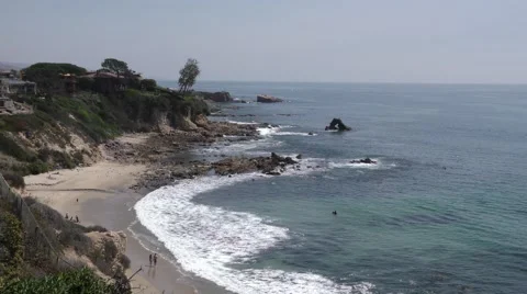 Idyllic Private California cove withe couple on beach and couple swimming per Stock Footage 67593690