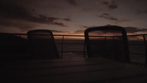 Idyllic Red Sunset Over Great Barrier Reef with Silhouetted Deck Chairs Stock Footage 314381092