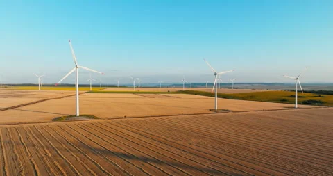 Idyllic rural aerial view featuring array wind turbines generating eco-friendly Stock Footage 301877385