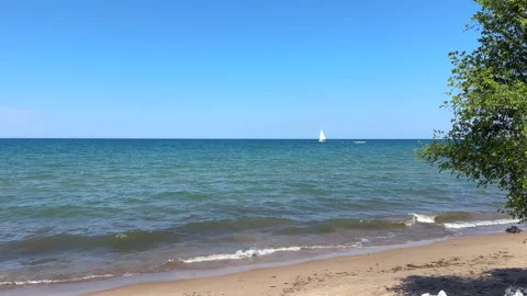 Idyllic scene of waves splashing onto a sandy beach of Lake Michigan Stock Footage 339228820