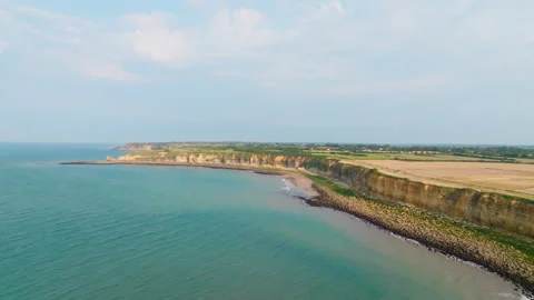 Idyllic Seascape with steep cliffs and Green Farmland Horizon Stock Footage 316237335