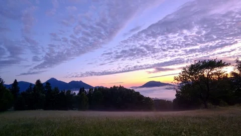 Idyllic spring landscape at dusk, colored sky and fog in the valley, between day Stock-Footage 301647775