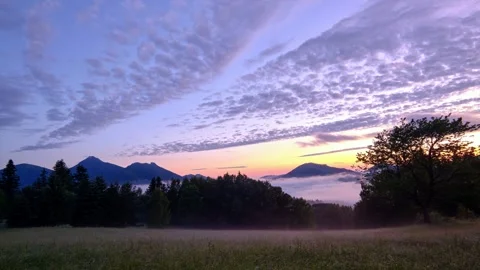Idyllic spring landscape at dusk, colored sky and fog in the valley, between day Stock Footage 301647796