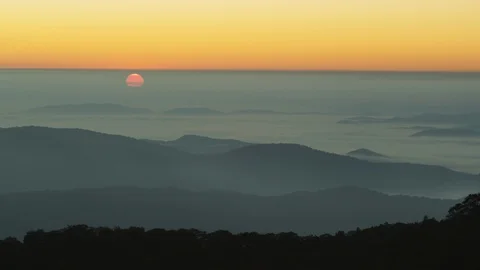 Idyllic sunset over the silhouetted mountain ranges Stock Footage 103825856
