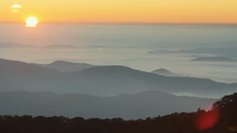 Idyllic sunset over the silhouetted mountain ranges Stock Footage 103825876