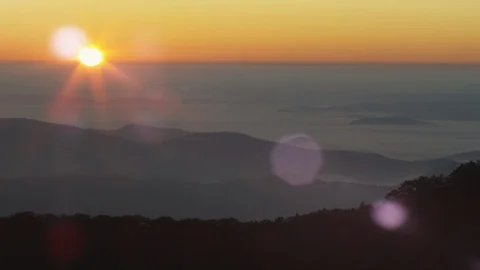 Idyllic sunset over the silhouetted mountain ranges Stock Footage 103825904