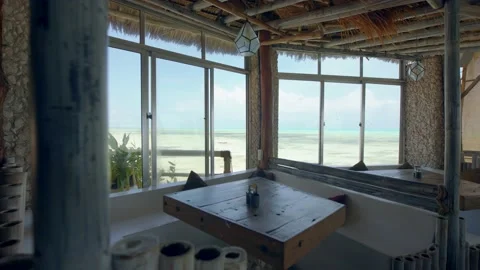 Idyllic table at restaurant looking out over beautiful tropical island view Stock Footage 148529643