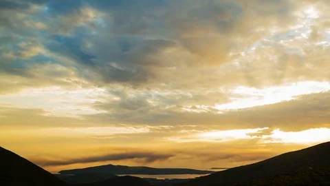 Idyllic Timelapse Shot Of Orange Clouds Rolling Over Silhouette Mountains Stock Footage 70837400