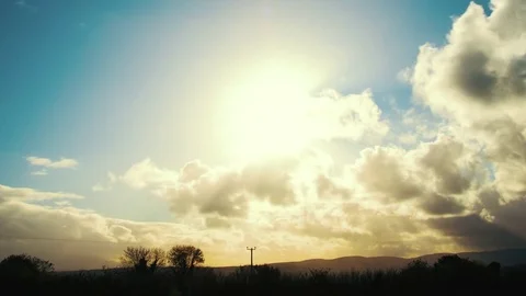 Idyllic Timelapse Of Sun Seen Through Rolling Clouds Over Field Stock Footage 71124314