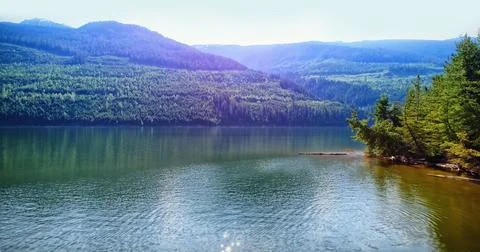 Idyllic view of river and mountains against sky Stock Illustration