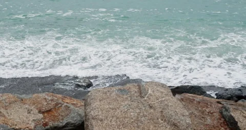 Idyllic view of waves splashing on rocks at seashore Stock Footage 266492960