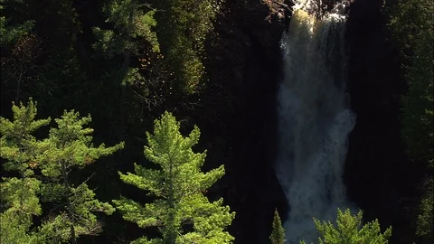 Idyllic waterfall flowing from the mountain surrounded with green trees Stock Footage 109136507