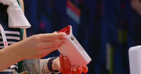 IFA Berlin—close-up of hands holding a compact modem device prototype, turning Video stock 327713628