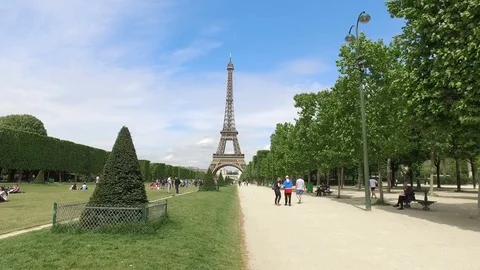 Iffel Tower Hyperlapse with Champs de Mars spring trees and tourist relaxing Stock Footage 99148585