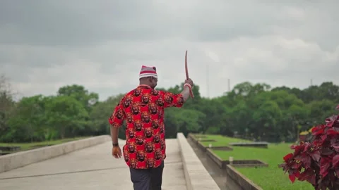Igbo titled man greets his people waving his mantle in approval. Stock Footage 283985019