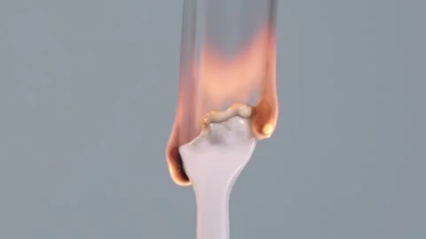 An ignited white disposable plastic ware, isolated on a grey background, burns Stock Footage 264406485