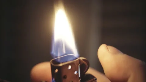 Igniting and talking gasoline lighter close up Stock-Footage 153117750