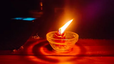 An igniting candle in glass jar Stock Footage 207970468
