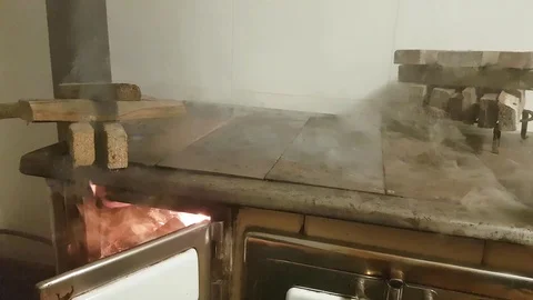 Igniting fire and smoke in solid-fuel range cooker, lighting fire in a wood oven Stock Footage 127030478