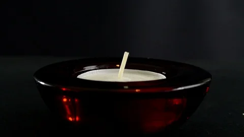 Igniting fire on candle with match in dark room Stock Footage 95621589