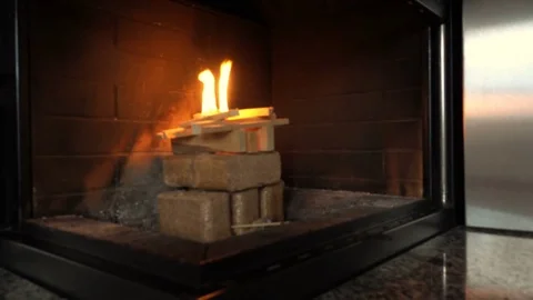 Igniting fire in fireplace at modern home Stock Footage 82217663