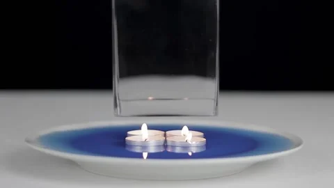 Igniting four candles in the water and glass Stock-Footage 158908196