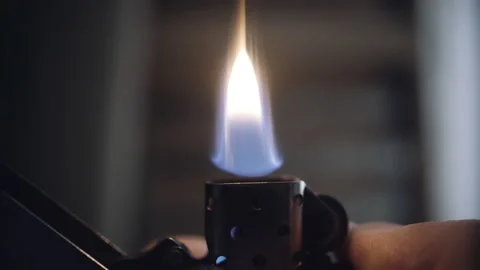 Igniting a gasoline lighter close-up Stock Footage 153117616