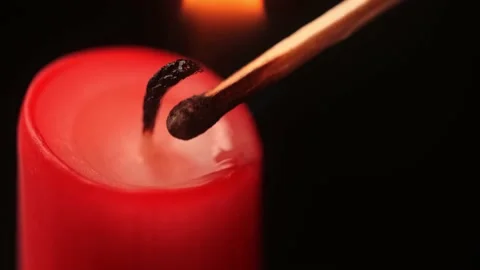 Igniting red candle with a match Stock Footage 152664641