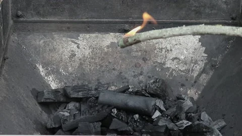 Ignition Coals For Grilling With A Lighter And Wood Branch . Fire Close-up Stock Footage 236689237
