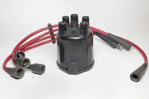 Ignition distributor cap, set of high tension cables, 4-slot holder, rubber.. Stock Photos