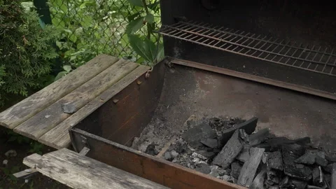 Ignition of the fire in the grill with the help of the ignition fluid. Stock Footage 135192581