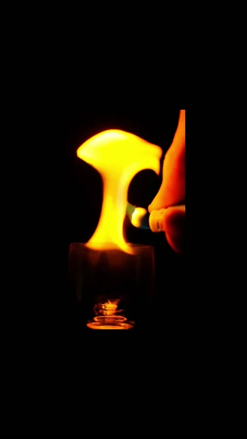 Ignition of flame in the wineglass on the black background in slow motion. verti Vídeos de archivo 169848817