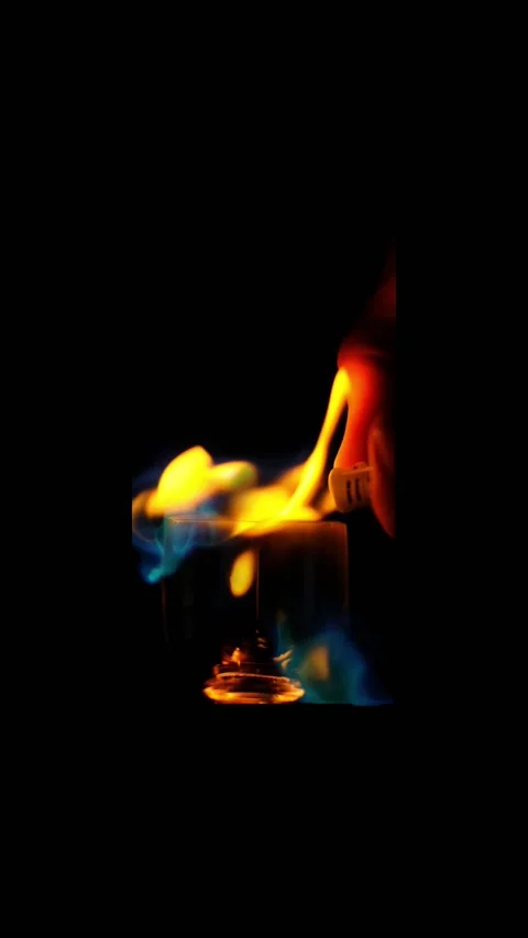 Ignition of flame in the wineglass on the black background in slow motion. verti Stock Footage 169848832