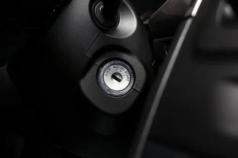 Ignition key lock in the interior of a large black car Stock Photos