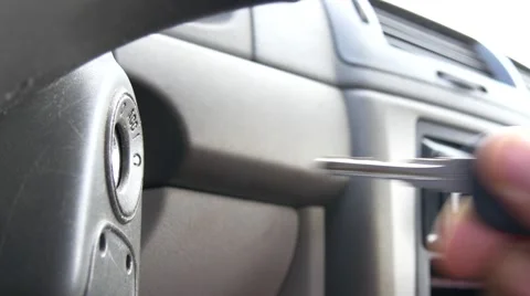 An ignition key is put into the ignition and starts the car Stock Footage 66655480