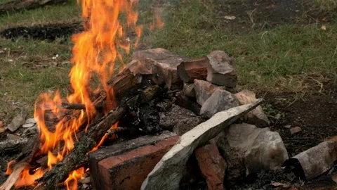 The ignition is poured into the bonfire. The fire breaks out and flares up with Stock-Footage 169418166