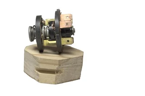 Ignition starter switch, inner part with terminal set, on wooden stand Stock Photos