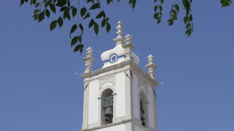 Igreja Matriz Bell Tower and Clock Against Blue Sky in Sesimbra Portugal Stock Footage 345076035
