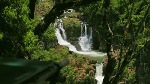 Iguazu Falls waterfalls with multiple cascading streams over rocky cliffs in Stock Footage 334122738