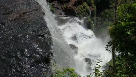Iguazu river flowing over cliff into gorge, Iguazu Falls in Argentina 動画素材 335197048