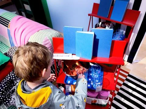 Ikea Child Exploring Glassware 스톡 사진